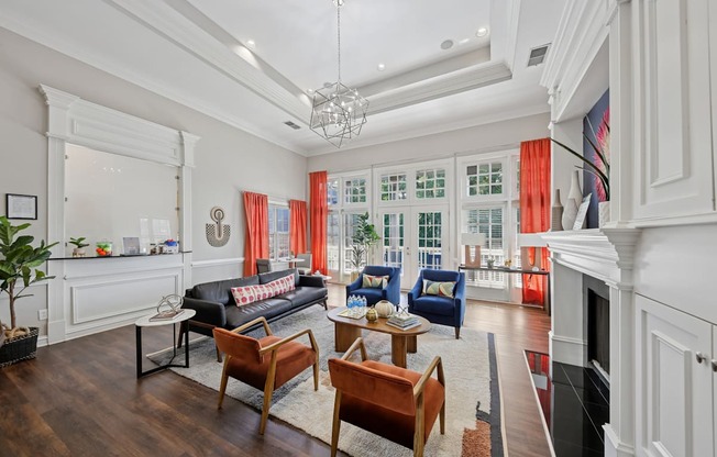 A living room with a black couch and a fireplace.