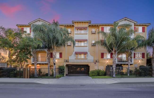 a street view of an apartment building with palm trees at Dronfield Astoria, 13140 Dronfield Ave