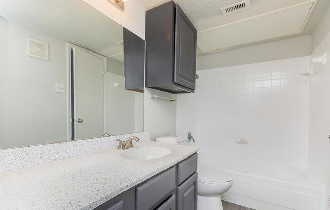 a kitchen with a sink and a mirror