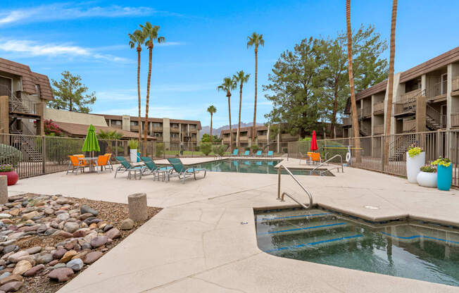 Resort Style Pool and Sundeck with Palm Trees at Verde Apartments in Tucson, AZ.