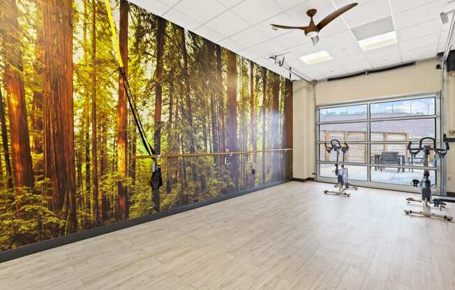 a yoga studio with a large mural of a forest
