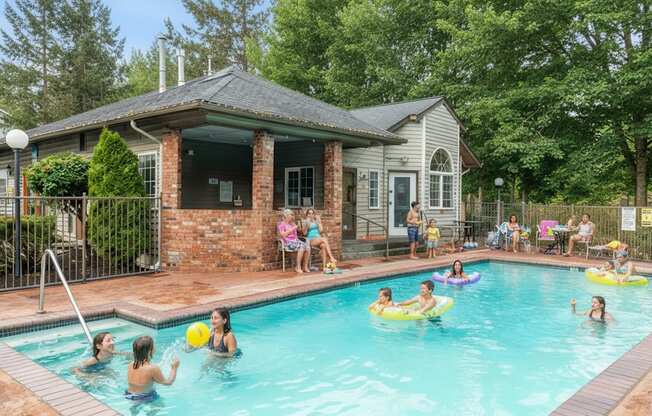 A group of people are enjoying a day in a pool.