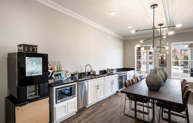 a kitchen and dining room with a table and a television at Arlo Luxury homes Apartments, Little Rock, AR