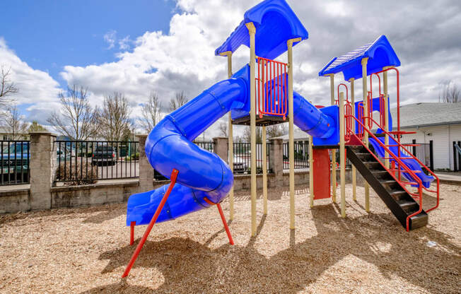 a playground with a blue and red slide