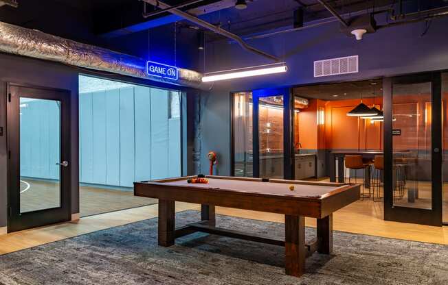 a pool table in a room with glass doors