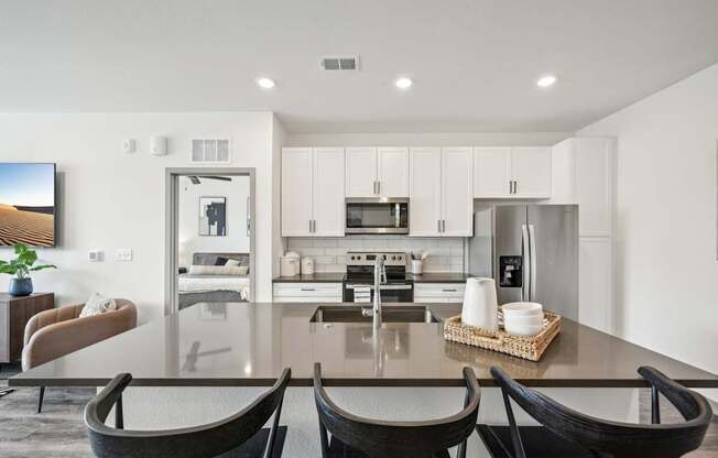 a kitchen and dining room with a table and chairs at The Quarry Luxury Apartment Homes, Fort Collins, 80526