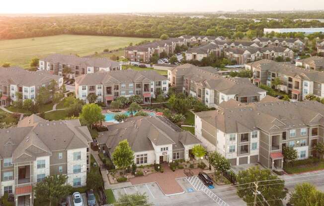 an aerial view of a neighborhood with houses and a swimming pool