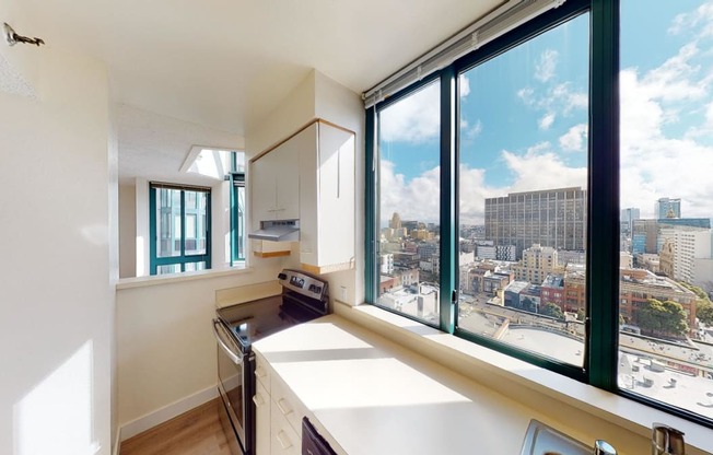 a kitchen with a large window and a city view