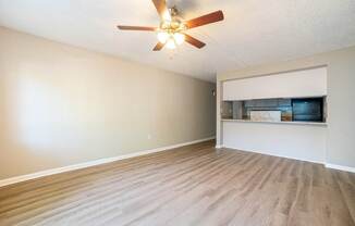 A room with a ceiling fan and light fixture.