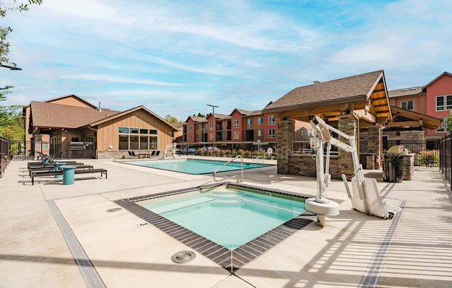 A large outdoor swimming pool with a slide and sun loungers.