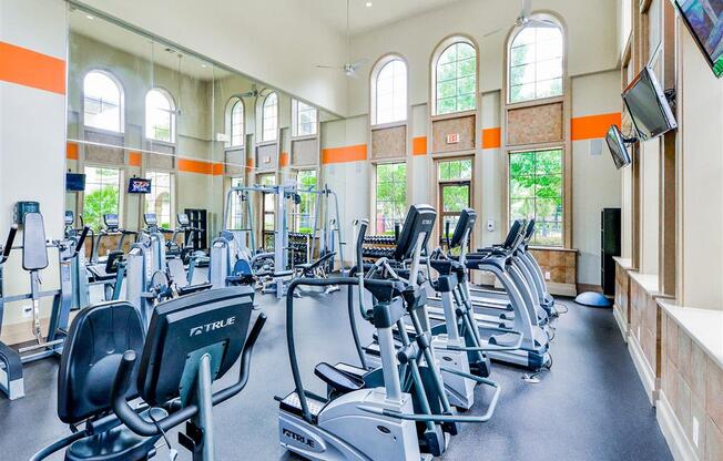 High energy fitness center fully equipped with fitness equipment in the Mission at La Villita Apartments in Irving, TX