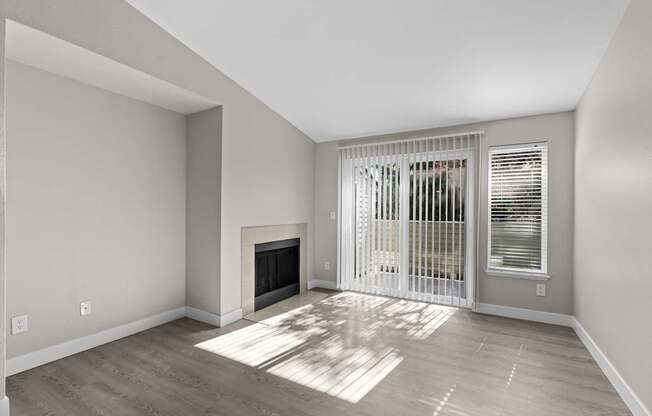 The Marina at Martha Lake Apartments in Bothell, WA Living Room with Fireplace and Private Patio