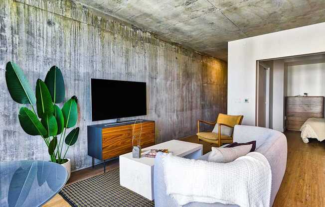 A living room with a white couch and a wooden cabinet.