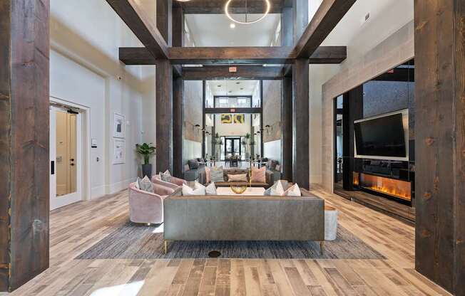 A modern living room with a fireplace and a large couch.