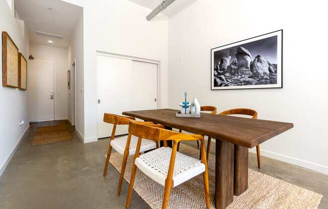 a dining room with a wooden table and chairs