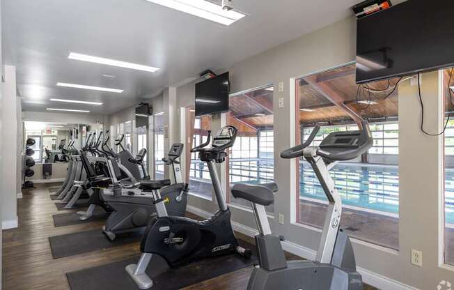 A gym with treadmills and exercise bikes.