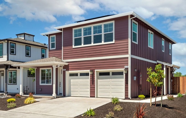 a red house with a garage door in front of it