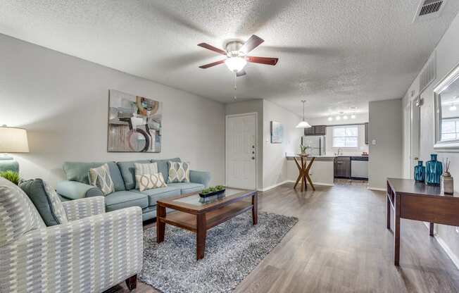A living room with a couch, chair, and coffee table.