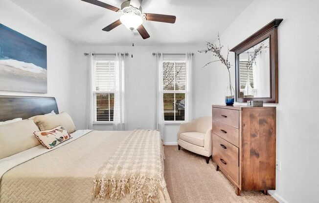 a bedroom with a bed and a ceiling fan