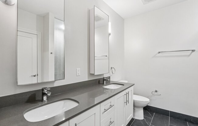Bathroom with 2 sinks and mirrors and toilet at Park77 Apartments, Cambridge, Massachusetts, 02138