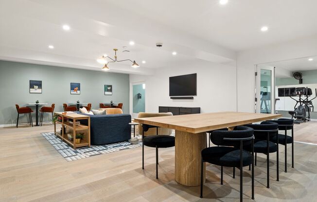 a living room and dining room with a table and chairs