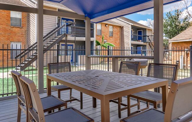 a couple of lawn chairs sitting on top of a wooden table