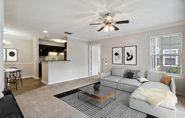 Model living room with view of kitchen