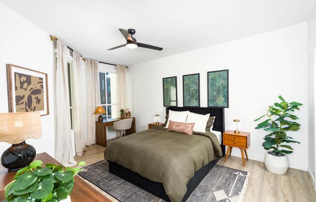 A calming primary bedroom at Modera Higley Commons, featuring soft natural light, refined finishes, and a layout designed for everyday comfort.