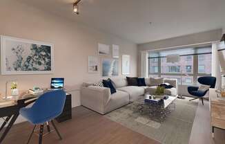 A modern living room with a blue chair and a white couch.