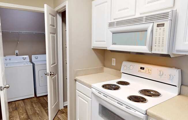 apartment kitchen with appliances including microwave