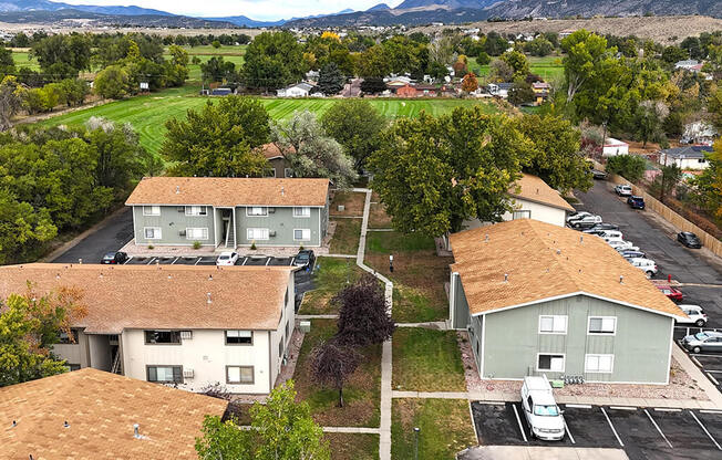 an aerial view of some houses and a parking lot