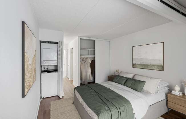 Model bedroom with a bed, a nightstand, and a painting on the wall.