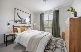 a bedroom with a bed and a dresser