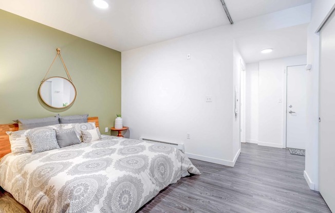 a bedroom with a bed and a mirror