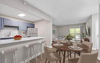 A kitchen with a dining table set for four. at Mill House at East Cobb, Marietta, 30067