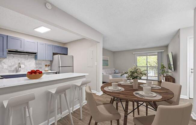 A kitchen with a dining table set for four. at Mill House at East Cobb, Marietta, 30067