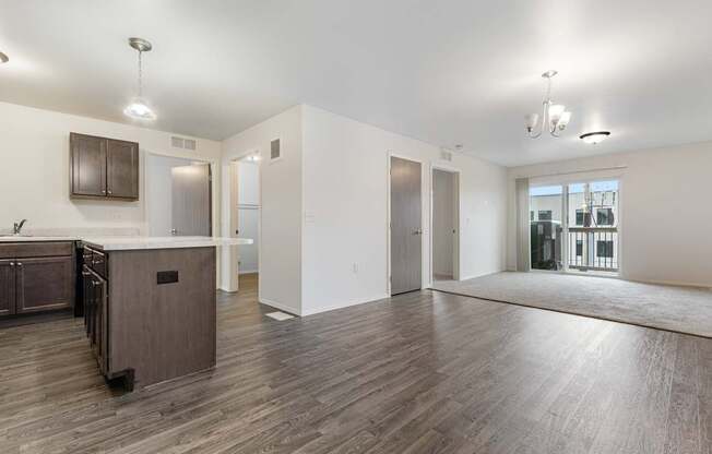 A spacious kitchen with wooden floors and a large island.