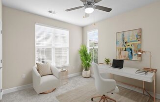 a room with a desk and a chair and a ceiling fan