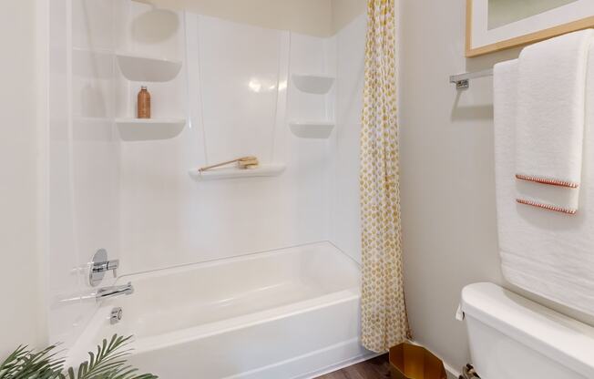 a bathroom with a shower and a sink and a tub