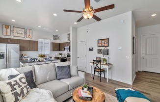 a living room with a couch and a ceiling fan