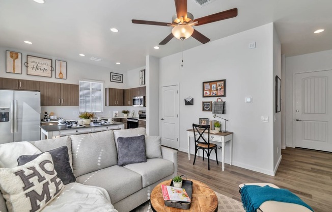 a living room with a couch and a ceiling fan