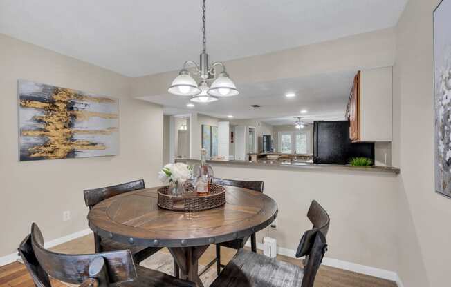 a dining room with a table and chairs and a kitchen