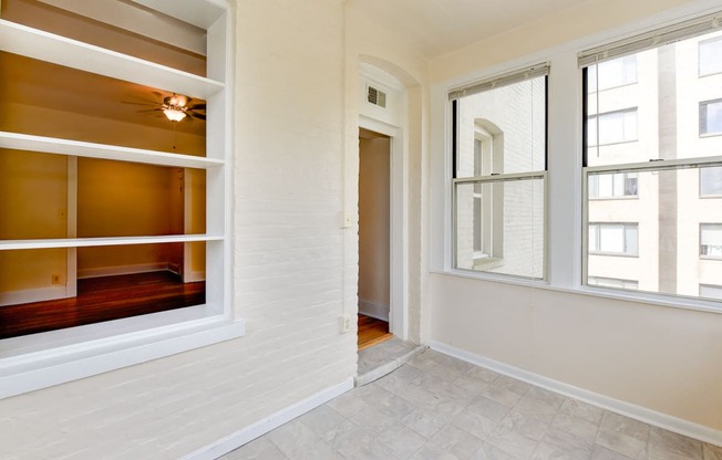 vacant sunroom with hardwood floors and large windows at twin oaks apartments columbia heights washington dc