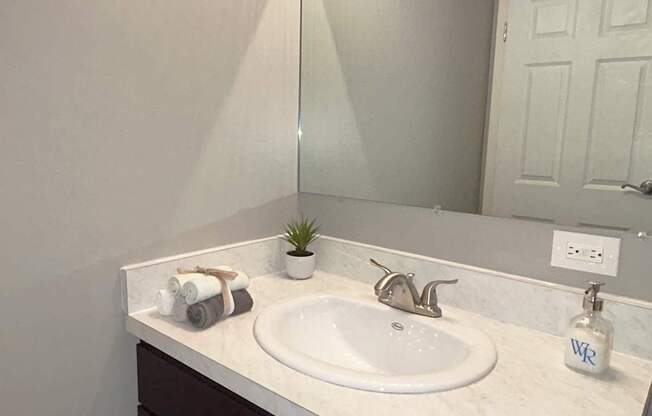A bathroom sink with a mirror above it.