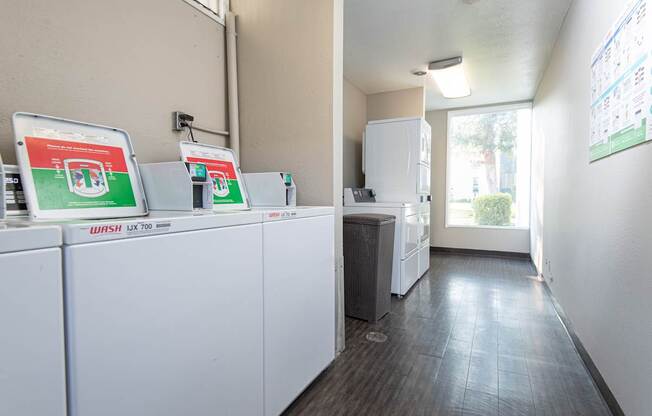 A row of white Wash UT appliances are lined up in a room.