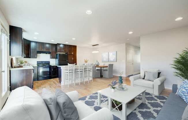 a living room and kitchen with white couches and a table at Copper Pines, Montana