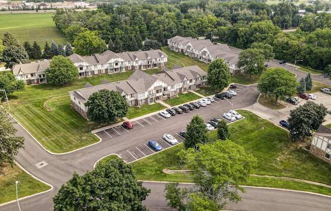 arial view of a subdivision with houses and parking lot at Beacon Hill and Great Oaks Apartments, Illinois, 61109