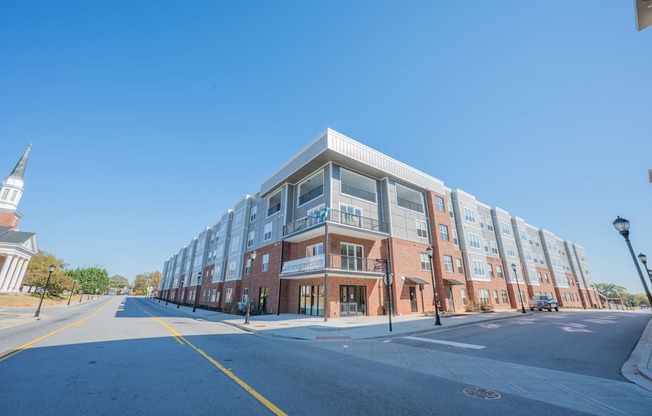 a large brick building with a street in front of it