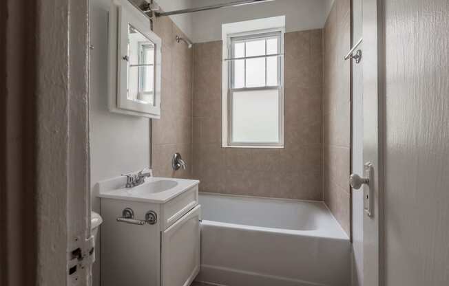 a bathroom with a bathtub and a sink