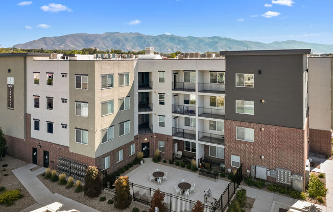 an aerial view of an apartment complex with mountains in the background